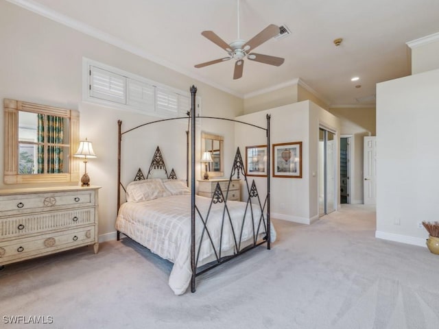 carpeted bedroom featuring ceiling fan and ornamental molding