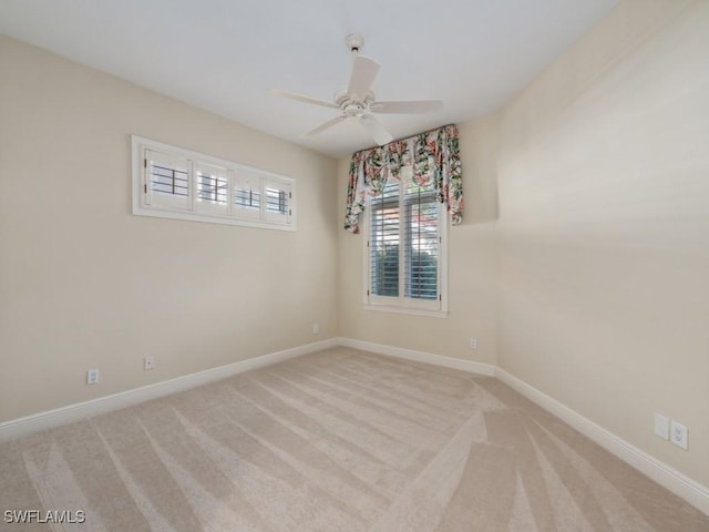 unfurnished room featuring light carpet and ceiling fan