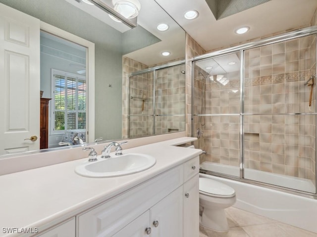 full bathroom featuring tile patterned flooring, vanity, toilet, and enclosed tub / shower combo