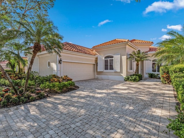 mediterranean / spanish home featuring a garage