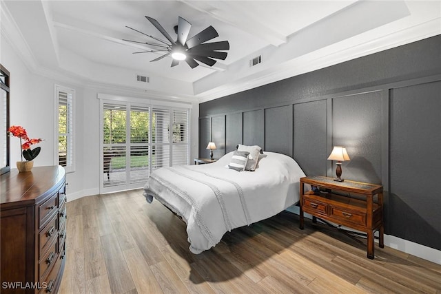 bedroom with beam ceiling, access to outside, ceiling fan, and light hardwood / wood-style floors