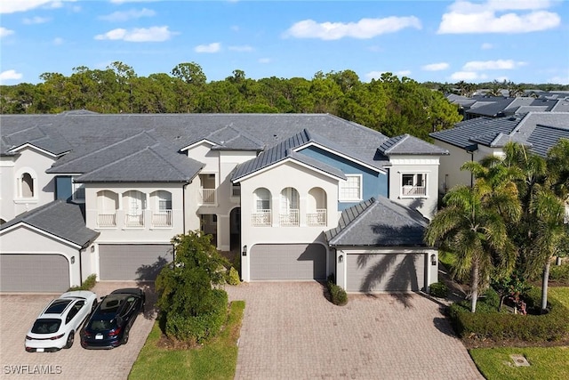 view of front facade featuring a balcony and a garage