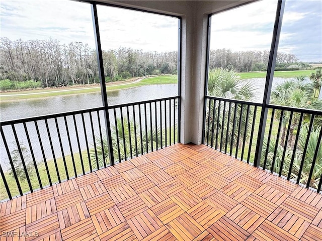 unfurnished sunroom featuring a water view