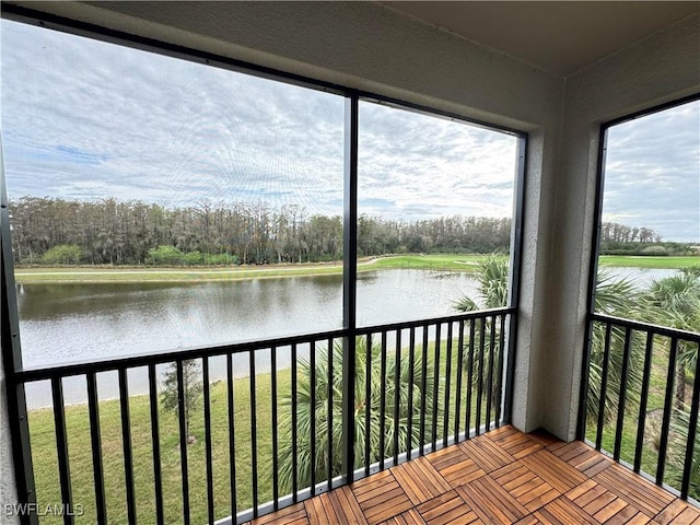 unfurnished sunroom with a water view