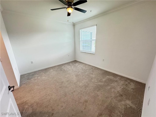 carpeted spare room featuring ornamental molding and ceiling fan