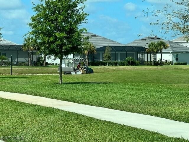 view of property's community with a lawn