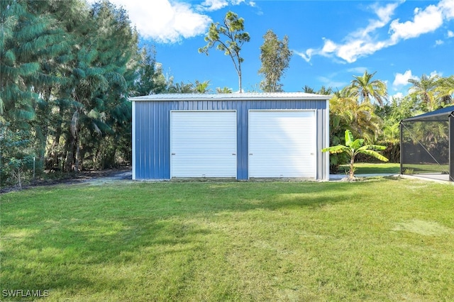 view of outdoor structure with a lawn and a garage