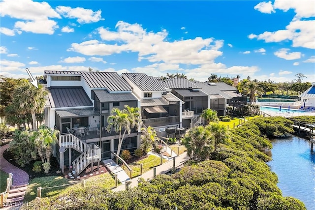 birds eye view of property with a water view