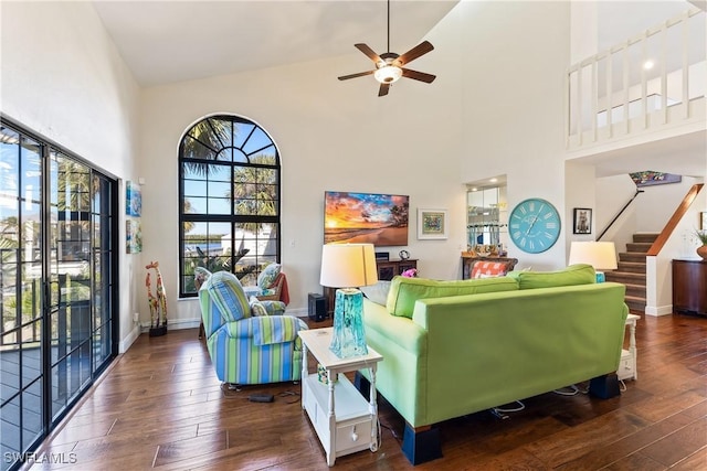 living room featuring ceiling fan, dark hardwood / wood-style flooring, and high vaulted ceiling