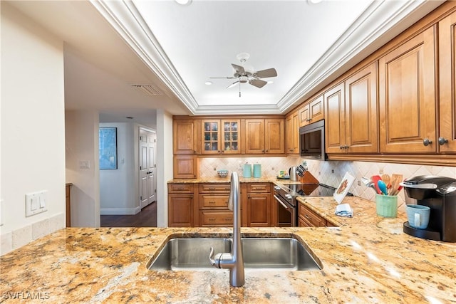 kitchen featuring sink, light stone countertops, stainless steel range with electric cooktop, and tasteful backsplash