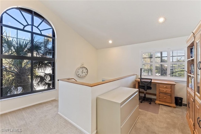 carpeted office space featuring lofted ceiling