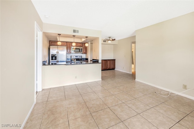 kitchen with ceiling fan, hanging light fixtures, kitchen peninsula, light tile patterned floors, and appliances with stainless steel finishes