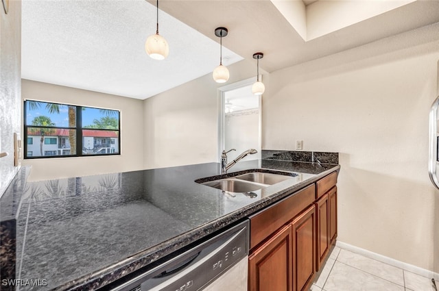 kitchen with dark stone counters, sink, hanging light fixtures, stainless steel dishwasher, and light tile patterned floors