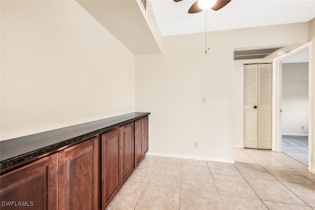 interior space featuring ceiling fan and light tile patterned floors