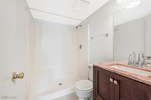 bathroom featuring tile patterned floors, toilet, vanity, and walk in shower