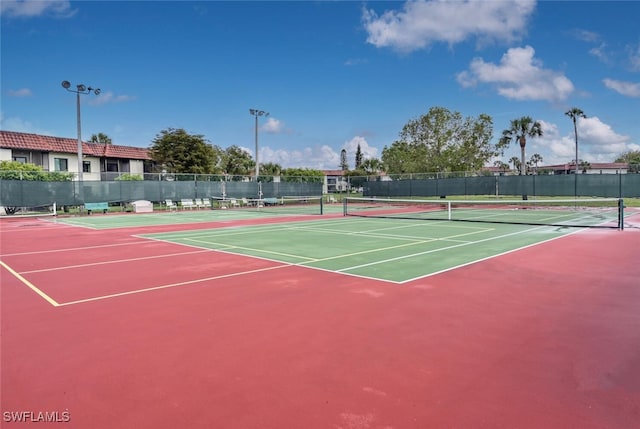 view of tennis court with basketball hoop