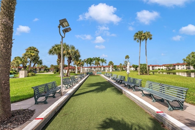 view of community with a water view and a yard