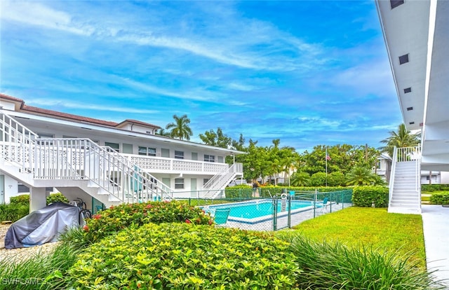 view of swimming pool featuring a lawn and area for grilling