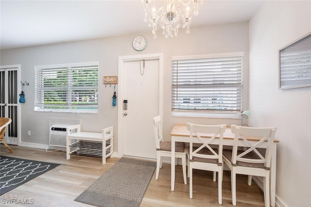 532 4th Ave S Unit 2, Naples, FL 34102 - dining room featuring a chandelier, wood finished floors, and a wall unit AC