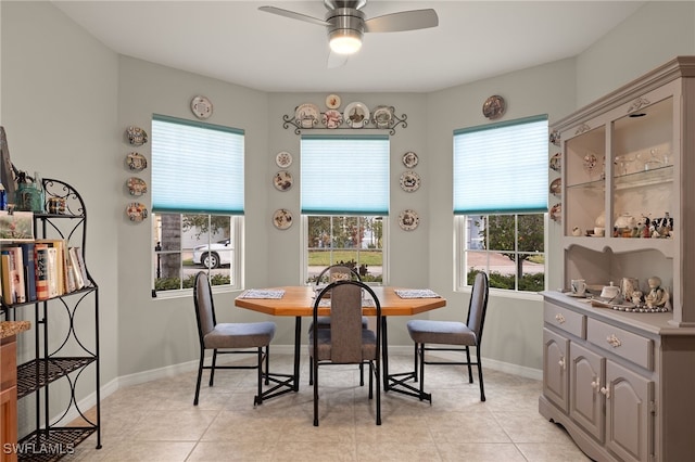 tiled dining area with ceiling fan