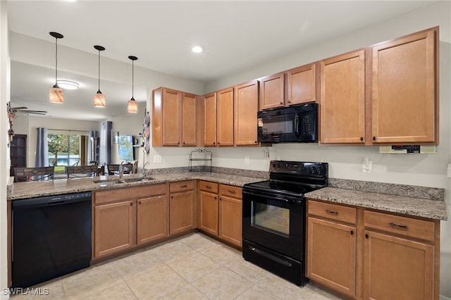 kitchen with kitchen peninsula, ceiling fan, sink, black appliances, and pendant lighting