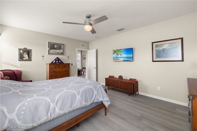 bedroom with hardwood / wood-style floors and ceiling fan