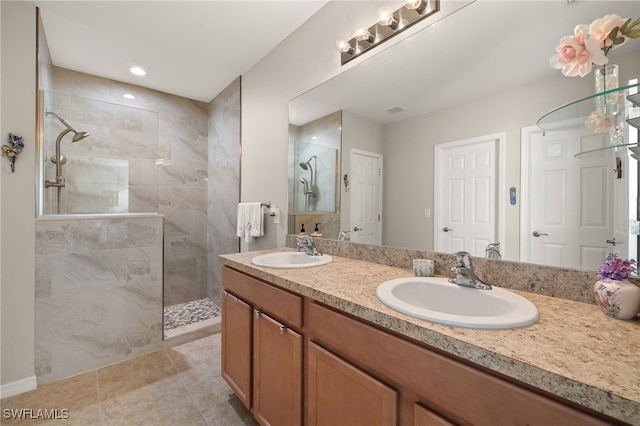 bathroom featuring vanity and tiled shower