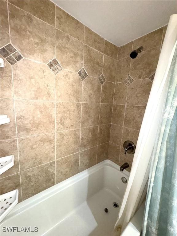 bathroom with shower / bathtub combination with curtain