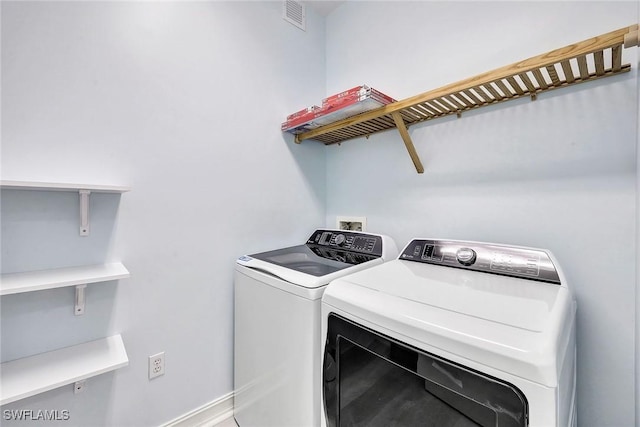 clothes washing area featuring washing machine and clothes dryer