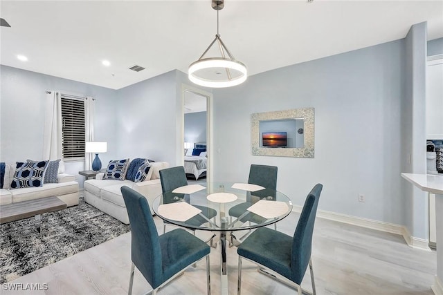 dining room with light hardwood / wood-style flooring