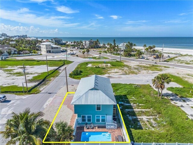 birds eye view of property featuring a beach view and a water view