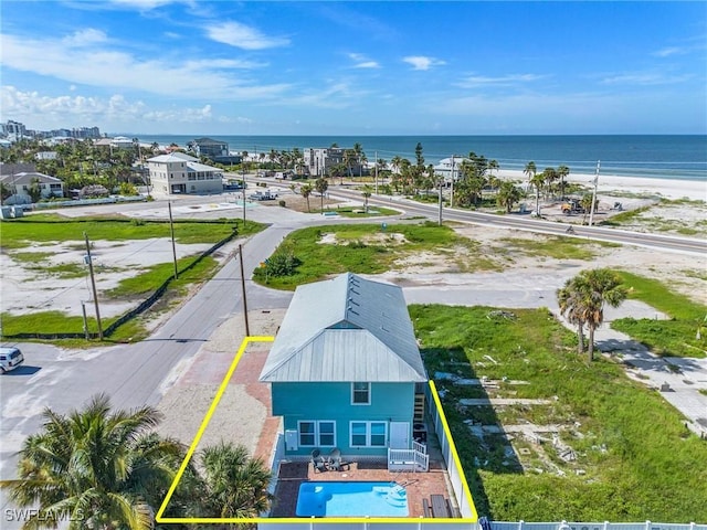 aerial view with a water view and a beach view