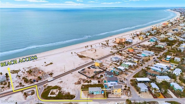 drone / aerial view featuring a view of the beach and a water view