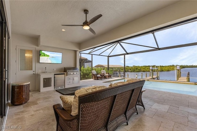 view of patio / terrace with ceiling fan, a grill, area for grilling, glass enclosure, and a water view