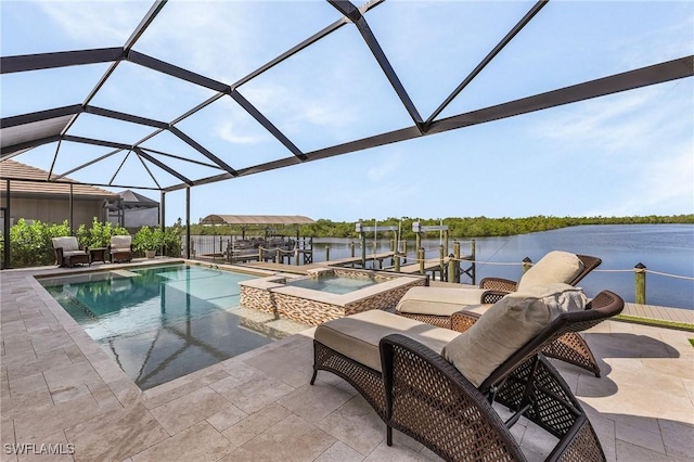 view of swimming pool with glass enclosure, an in ground hot tub, a patio area, a dock, and a water view