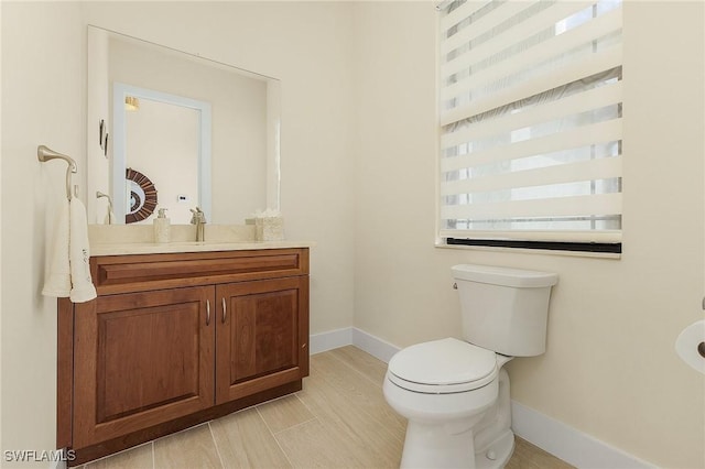 bathroom featuring toilet and vanity