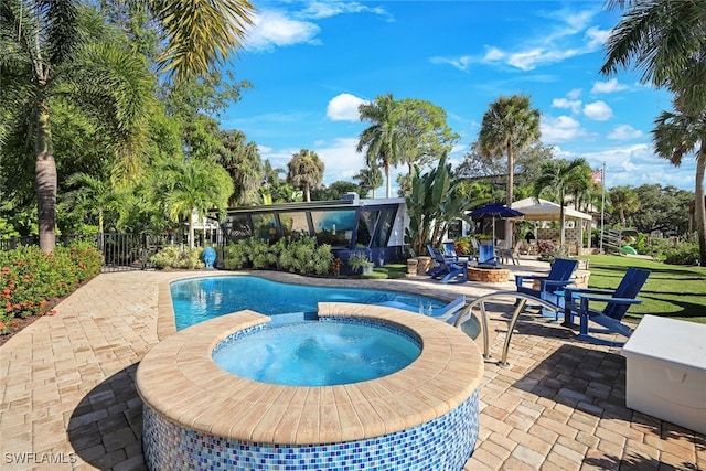 view of pool featuring an in ground hot tub and a patio