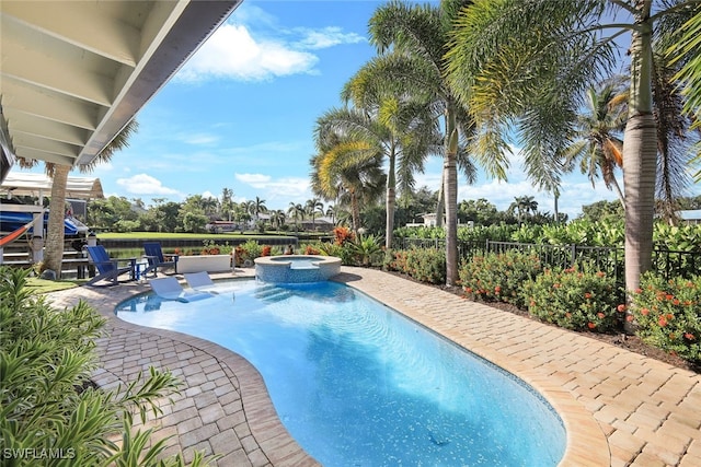 view of pool featuring a patio area and an in ground hot tub