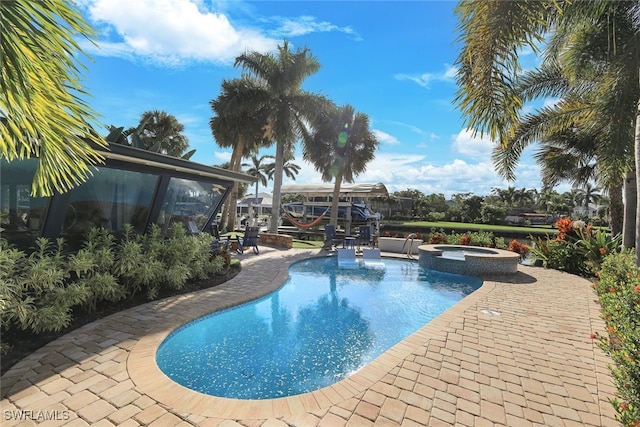 view of swimming pool featuring an in ground hot tub