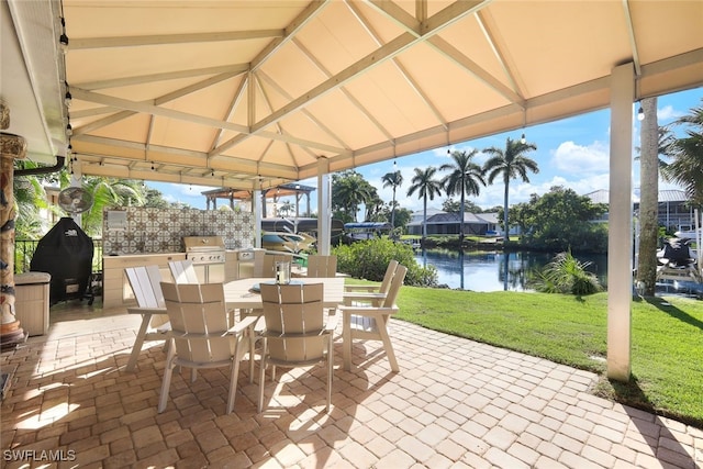 view of patio with a gazebo, a water view, and a grill