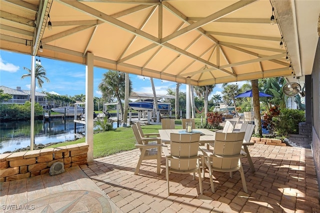 view of patio featuring a gazebo and a water view