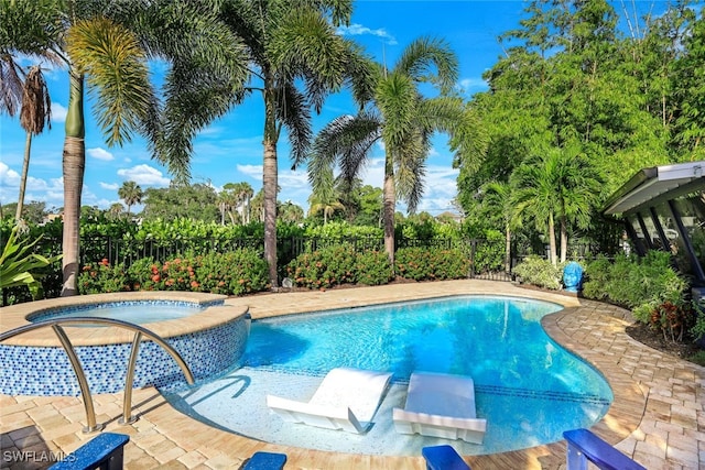 view of swimming pool with a patio area and an in ground hot tub