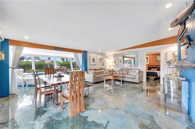 dining room with a wall mounted air conditioner and vaulted ceiling