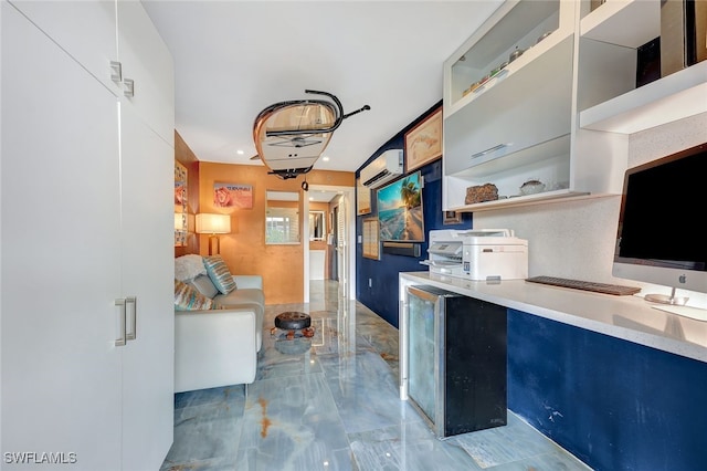 kitchen with a wall unit AC and blue cabinets