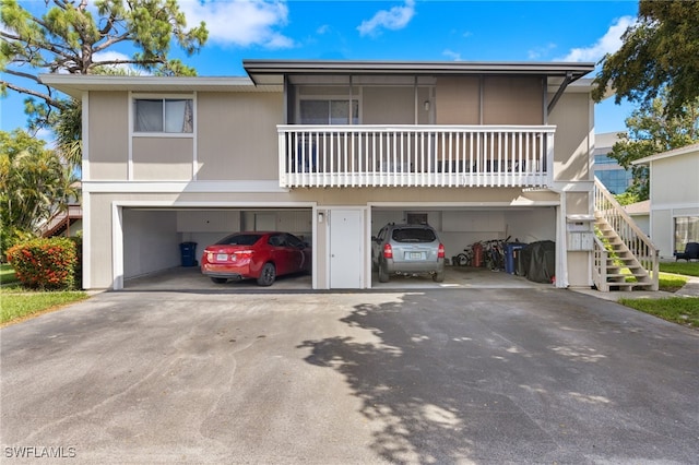 view of front of house featuring a balcony and a garage