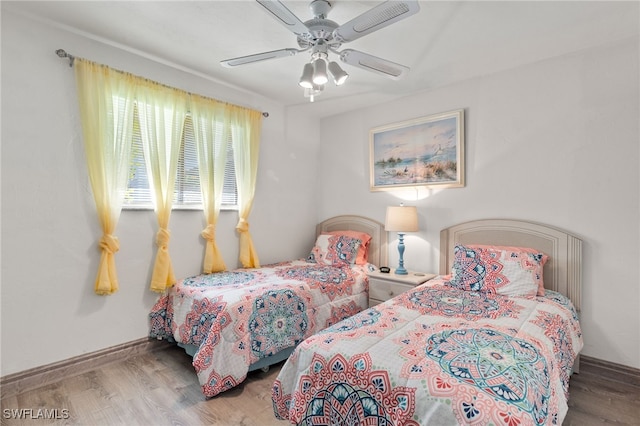 bedroom featuring ceiling fan and wood-type flooring