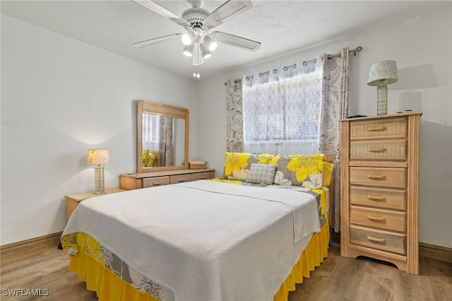 bedroom featuring light wood-type flooring and ceiling fan