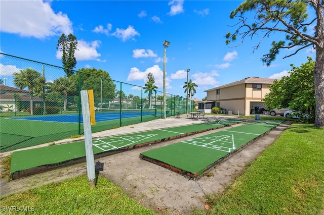 view of property's community featuring tennis court