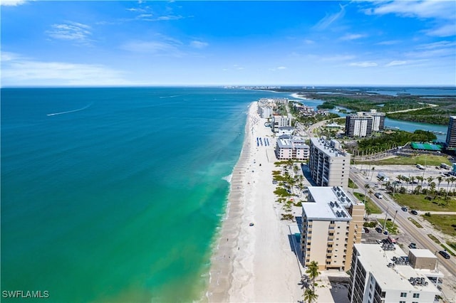 birds eye view of property with a beach view and a water view