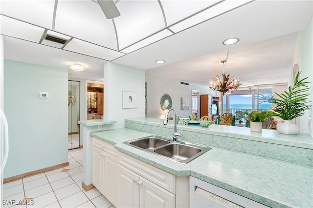 26340 Hickory Blvd Unit 703, Bonita Springs, FL 34134 - kitchen featuring dishwasher, light countertops, white cabinets, decorative light fixtures, and light tile patterned flooring